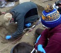 scientists working on burial site